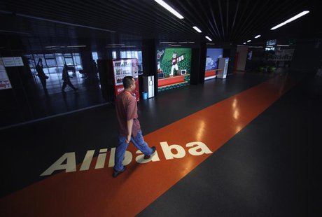 An employee walks past a logo of Alibaba (China) Technology Co. Ltd during a media tour organised by government officials at its headquarter An employee walks past a logo of Alibaba (China) Technology Co. Ltd during a media tour organised by government officials at its headquarter