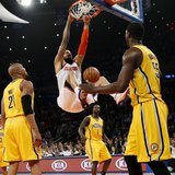 New York Knicks' Tyson Chandler (C) dunks past Indiana Pacers' David West (L) and Roy Hibbert (R) during the second quarter in Game 2 of the