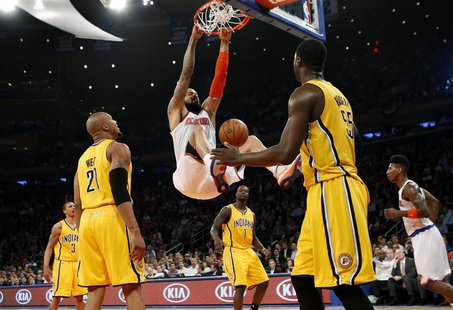New York Knicks' Tyson Chandler (C) dunks past Indiana Pacers' David West (L) and Roy Hibbert (R) during the second quarter in Game 2 of the New York Knicks' Tyson Chandler (C) dunks past Indiana Pacers' David West (L) and Roy Hibbert (R) during the second quarter in Game 2 of the