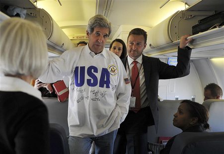 U.S. Secretary of State John Kerry (C) talks to journalists on board his plane after his departure from Moscow May 8, 2013. REUTERS/Mladen A U.S. Secretary of State John Kerry (C) talks to journalists on board his plane after his departure from Moscow May 8, 2013. REUTERS/Mladen A