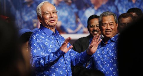 Malaysia's Prime Minister Najib Razak (L) and his deputy Muhyiddin Yassin share a light moment after winning the elections at his party head Malaysia's Prime Minister Najib Razak (L) and his deputy Muhyiddin Yassin share a light moment after winning the elections at his party head