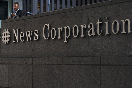 A passer-by stands in front of the News Corporation building in New York June 28, 2012. REUTERS/Keith Bedford A passer-by stands in front of the News Corporation building in New York June 28, 2012. REUTERS/Keith Bedford
