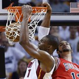 Miami Heat's Chris Bosh (L) slam dunks over Chicago Bulls' Joakim Noah during Game 2 of their NBA Eastern Conference semi-final basketball p