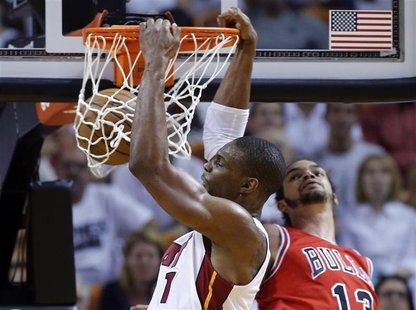 Miami Heat's Chris Bosh (L) slam dunks over Chicago Bulls' Joakim Noah during Game 2 of their NBA Eastern Conference semi-final basketball p Miami Heat's Chris Bosh (L) slam dunks over Chicago Bulls' Joakim Noah during Game 2 of their NBA Eastern Conference semi-final basketball p