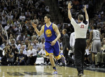 Golden State Warriors guard Klay Thompson reacts after hitting a three-point shot against the San Antonio Spurs during the second half of th Golden State Warriors guard Klay Thompson reacts after hitting a three-point shot against the San Antonio Spurs during the second half of th