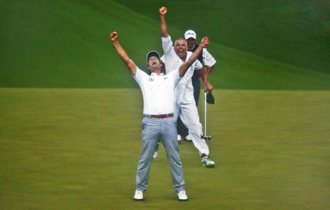 Adam Scott of Australia (L) celebrates winning the Masters with caddie Steve Williams (C) in front of Angel Cabrera of Argentina (R) on the Adam Scott of Australia (L) celebrates winning the Masters with caddie Steve Williams (C) in front of Angel Cabrera of Argentina (R) on the