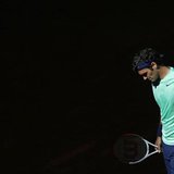 Roger Federer of Switzerland reacts after losing a point to Kei Nishikori of Japan during their men's singles match at the Madrid Open tenni