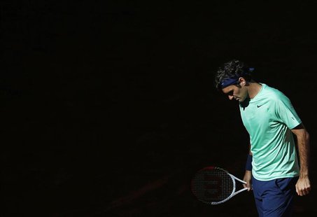 Roger Federer of Switzerland reacts after losing a point to Kei Nishikori of Japan during their men's singles match at the Madrid Open tenni Roger Federer of Switzerland reacts after losing a point to Kei Nishikori of Japan during their men's singles match at the Madrid Open tenni