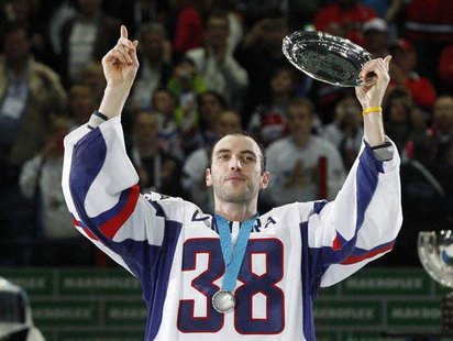 Slovakia's Zdeno Chara wears jersey with the number of the former Slovak national team captain Pavol Demitra as he holds a trophy after thei Slovakia's Zdeno Chara wears jersey with the number of the former Slovak national team captain Pavol Demitra as he holds a trophy after thei
