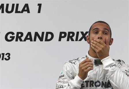 Mercedes Formula One driver Lewis Hamilton of Britain reacts on the winners' podium during the victory ceremony after the Chinese F1 Grand P Mercedes Formula One driver Lewis Hamilton of Britain reacts on the winners' podium during the victory ceremony after the Chinese F1 Grand P