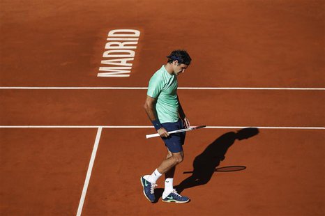 Roger Federer of Switzerland reacts after losing a point to Kei Nishikori of Japan during their men's singles match at the Madrid Open tenni Roger Federer of Switzerland reacts after losing a point to Kei Nishikori of Japan during their men's singles match at the Madrid Open tenni
