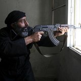 A Free Syrian Army fighter aims his AK-47 rifle through a window in Aleppo's Salaheddine neighbourhood April 28, 2013. Picture taken April 2