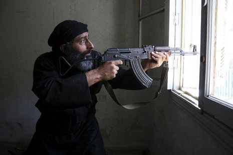 A Free Syrian Army fighter aims his AK-47 rifle through a window in Aleppo's Salaheddine neighbourhood April 28, 2013. Picture taken April 2 A Free Syrian Army fighter aims his AK-47 rifle through a window in Aleppo's Salaheddine neighbourhood April 28, 2013. Picture taken April 2