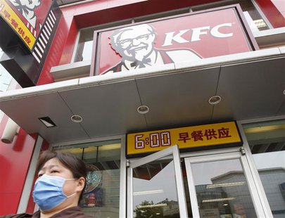 A woman wearing a mask walks out of a KFC restaurant in Beijing, May 9, 2013. REUTERS/Kim Kyung-Hoon A woman wearing a mask walks out of a KFC restaurant in Beijing, May 9, 2013. REUTERS/Kim Kyung-Hoon