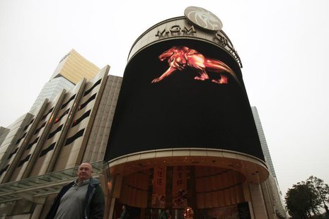 A visitor walks past the MGM Grand Macau resort in Macau February 15, 2011. REUTERS/Tyrone Siu A visitor walks past the MGM Grand Macau resort in Macau February 15, 2011. REUTERS/Tyrone Siu