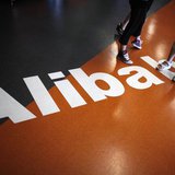 Employees stand on a logo of Alibaba (China) Technology Co. Ltd during a media tour organised by government officials at its headquarters on Employees stand on a logo of Alibaba (China) Technology Co. Ltd during a media tour organised by government officials at its headquarters on