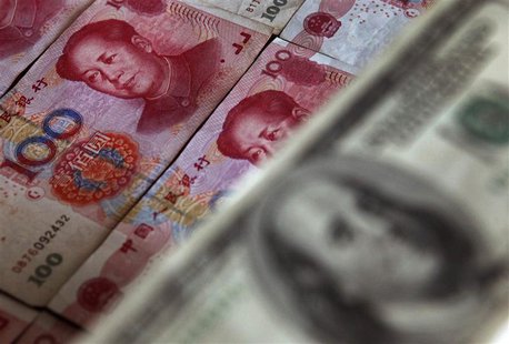 A photo illustration shows a $100 banknote placed above Chinese 100 yuan banknotes in Beijing May 10, 2013. REUTERS/Petar Kujundzic A photo illustration shows a $100 banknote placed above Chinese 100 yuan banknotes in Beijing May 10, 2013. REUTERS/Petar Kujundzic