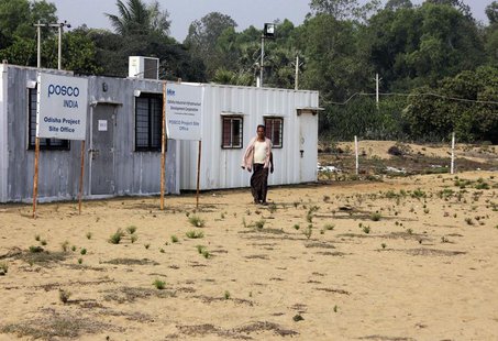 A villager walks at the POSCO India Odisha Project site office at Gobindpur village in Jagatsinghpur district, in the eastern Indian state o A villager walks at the POSCO India Odisha Project site office at Gobindpur village in Jagatsinghpur district, in the eastern Indian state o
