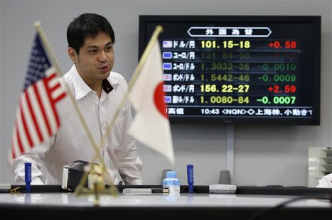 An employee of a foreign exchange trading company works next to a monitor displaying the Japanese yen's exchange rate against the U.S. dolla An employee of a foreign exchange trading company works next to a monitor displaying the Japanese yen's exchange rate against the U.S. dolla