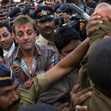 Bollywood actor Sanjay Dutt (C, with red mark on forehead), surrounded by Indian policemen, leaves a special court after getting bail in Mum