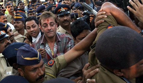 Bollywood actor Sanjay Dutt (C, with red mark on forehead), surrounded by Indian policemen, leaves a special court after getting bail in Mum Bollywood actor Sanjay Dutt (C, with red mark on forehead), surrounded by Indian policemen, leaves a special court after getting bail in Mum