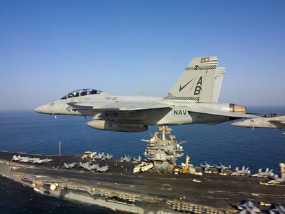 Two F/A-18 Super Hornets fly above the aircraft carrier USS Enterprise in this October 4, 2012 handout photo courtesy of the U.S. Navy. REUT Two F/A-18 Super Hornets fly above the aircraft carrier USS Enterprise in this October 4, 2012 handout photo courtesy of the U.S. Navy. REUT