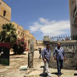 Libyans stand next to the scene of a blast after a bomb exploded outside police station in Benghazi May 10, 2013. REUTERS/Esam Al-Fetori