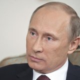 Russian President Vladimir Putin listens during an interview with German public broadcaster ARD at the Novo-Ogaryovo residence outside Mosco