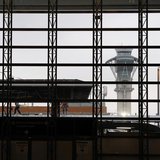 The air traffic control tower is seen through a window as construction workers work on the Tom Bradley International Terminal at Los Angeles The air traffic control tower is seen through a window as construction workers work on the Tom Bradley International Terminal at Los Angeles
