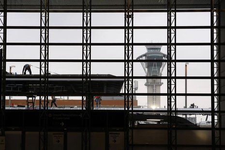 The air traffic control tower is seen through a window as construction workers work on the Tom Bradley International Terminal at Los Angeles The air traffic control tower is seen through a window as construction workers work on the Tom Bradley International Terminal at Los Angeles