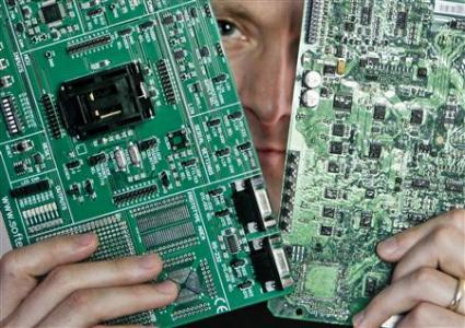 Security researcher Charlie Miller holds two automobile electronic control module circuit boards which posing in his home-office in Wildwood, Missouri, April 30, 2013.
REUTERS/Sarah Conard Security researcher Charlie Miller holds two automobile electronic control module circuit boards which posing in his home-office in Wildwood, Missouri, April 30, 2013.
REUTERS/Sarah Conard