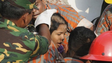 Rescue workers rescue a woman from the rubble of the collapsed Rana Plaza building, in Savar May 10, 2013.
REUTERS/Sanaul Huq Rescue workers rescue a woman from the rubble of the collapsed Rana Plaza building, in Savar May 10, 2013.
REUTERS/Sanaul Huq