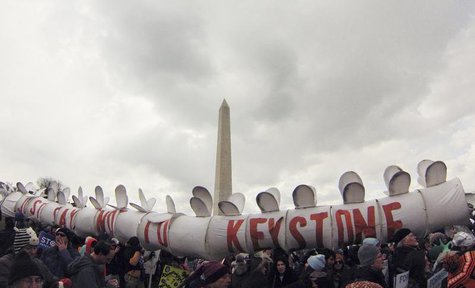 Demonstrators carry a replica of a pipeline during a march against the Keystone XL pipeline in Washington, February 17, 2013. REUTERS/Richar Demonstrators carry a replica of a pipeline during a march against the Keystone XL pipeline in Washington, February 17, 2013. REUTERS/Richar