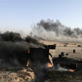 A man walks at a makeshift oil refinery site in al-Mansoura village in Raqqa's countryside May 5, 2013. REUTERS/Hamid Khatib