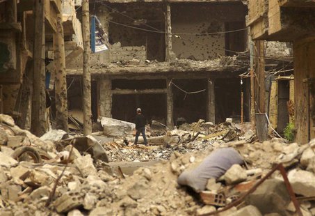 A resident makes his way through rubble of damaged buildings along a street in Deir al-Zor May 9, 2013. REUTERS/Khalil Ashawi A resident makes his way through rubble of damaged buildings along a street in Deir al-Zor May 9, 2013. REUTERS/Khalil Ashawi