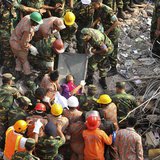 Rescue workers rescue a woman from the rubble of the Rana Plaza building 17 days after the building collapsed in Savar May 10, 2013. REUTERS Rescue workers rescue a woman from the rubble of the Rana Plaza building 17 days after the building collapsed in Savar May 10, 2013. REUTERS