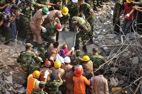 Rescue workers rescue a woman from the rubble of the Rana Plaza building 17 days after the building collapsed in Savar May 10, 2013. REUTERS Rescue workers rescue a woman from the rubble of the Rana Plaza building 17 days after the building collapsed in Savar May 10, 2013. REUTERS