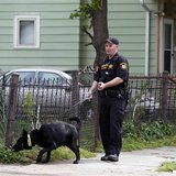 A Cuyahoga County Sheriff's deputy leads a dog through the neighborhood outside Ariel Castro's home in Cleveland, Ohio, May 10, 2013. REUTER A Cuyahoga County Sheriff's deputy leads a dog through the neighborhood outside Ariel Castro's home in Cleveland, Ohio, May 10, 2013. REUTER