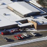 People put items from the old Sandy Hook School into garbage containers as they clean up the school in Sandy Hook, Connecticut January 3, 20
