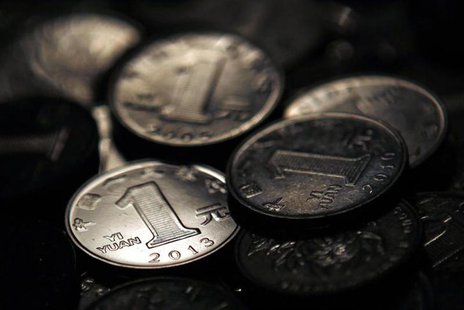 One Chinese yuan coins are seen in this photo illustration taken in Shanghai April 7, 2013. REUTERS/Carlos Barria One Chinese yuan coins are seen in this photo illustration taken in Shanghai April 7, 2013. REUTERS/Carlos Barria