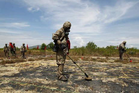 Soldiers detect Unexploded Ordnance (UXO) and defoliant Agent Orange during the launch of the "environmental remediation of dioxin contamina Soldiers detect Unexploded Ordnance (UXO) and defoliant Agent Orange during the launch of the "environmental remediation of dioxin contamina
