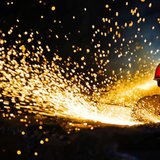 A worker wearing protective glasses welds steel products at a heavy equipment manufacturing factory in Luoyang, Henan province May 1, 2013. 