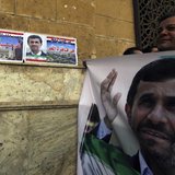A man holds a banner of Iran's President Mahmoud Ahmadinejad in front of the Al-Hussein mosque, named after Prophet Mohammed's grandson Huss