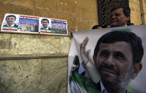 A man holds a banner of Iran's President Mahmoud Ahmadinejad in front of the Al-Hussein mosque, named after Prophet Mohammed's grandson Huss A man holds a banner of Iran's President Mahmoud Ahmadinejad in front of the Al-Hussein mosque, named after Prophet Mohammed's grandson Huss