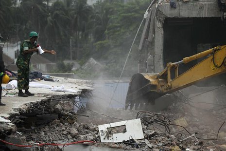Rescue workers attempt to find survivors from the rubble of the collapsed Rana Plaza building in Savar, around 30 km (19 miles) outside Dhak Rescue workers attempt to find survivors from the rubble of the collapsed Rana Plaza building in Savar, around 30 km (19 miles) outside Dhak