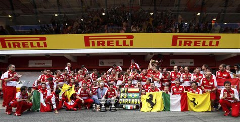 The Ferrari Formula One team pose for photographers with their trophies after drivers Fernando Alonso of Spain and Felipe Massa of Brazil wo The Ferrari Formula One team pose for photographers with their trophies after drivers Fernando Alonso of Spain and Felipe Massa of Brazil wo