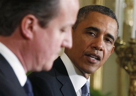 U.S. President Barack Obama (R) looks toward Britain's Prime Minister David Cameron (L) during a joint news conference in the East Room of t U.S. President Barack Obama (R) looks toward Britain's Prime Minister David Cameron (L) during a joint news conference in the East Room of t