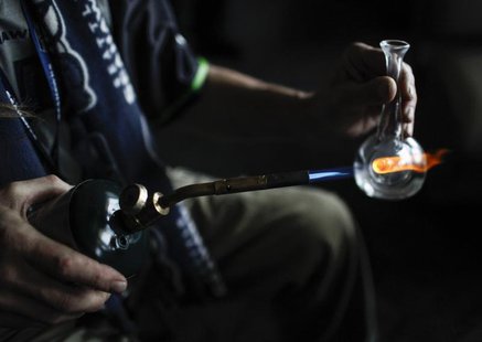 A customer heats up a pipe to smoke marijuana oil at Frankie Sports Bar and Grill in Olympia, Washington on December 9, 2012. REUTERS/Nick A A customer heats up a pipe to smoke marijuana oil at Frankie Sports Bar and Grill in Olympia, Washington on December 9, 2012. REUTERS/Nick A