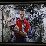 Canadian Space Agency astronaut Chris Hadfield, the commander of the International Space Station (ISS), is seen on a screen holding the new Canadian Space Agency astronaut Chris Hadfield, the commander of the International Space Station (ISS), is seen on a screen holding the new