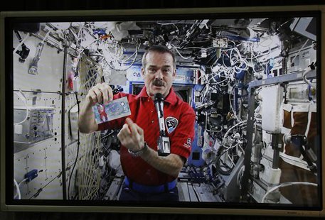 Canadian Space Agency astronaut Chris Hadfield, the commander of the International Space Station (ISS), is seen on a screen holding the new Canadian Space Agency astronaut Chris Hadfield, the commander of the International Space Station (ISS), is seen on a screen holding the new